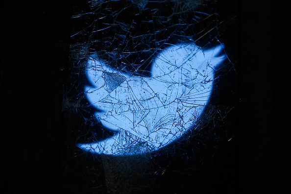 Twitter logo with scratches all over it.
