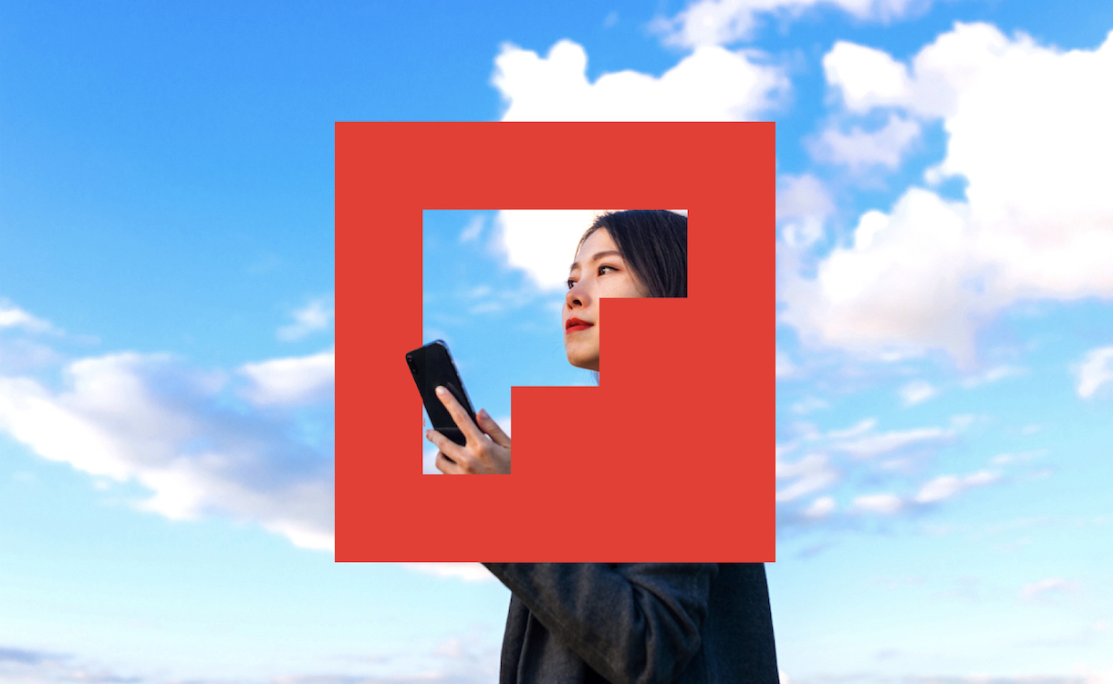 Flipboard's logo, a red square with a transparent F, with mostly blue sky behind it. In the middle is a woman holding a phone, mostly visible through the F-shaped opening in the logo.